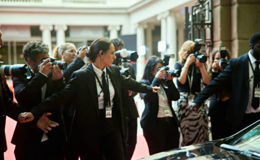 Executive protection team managing VIP event security and media crowd control
