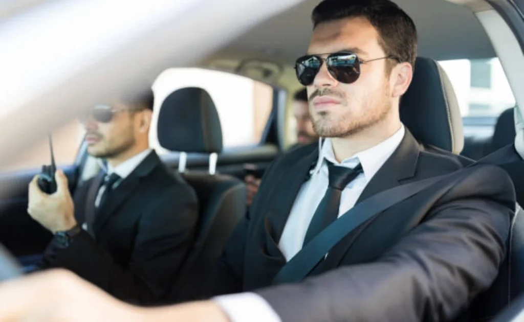 ARMSTEL executive driver providing secure VIP transport in premium vehicle