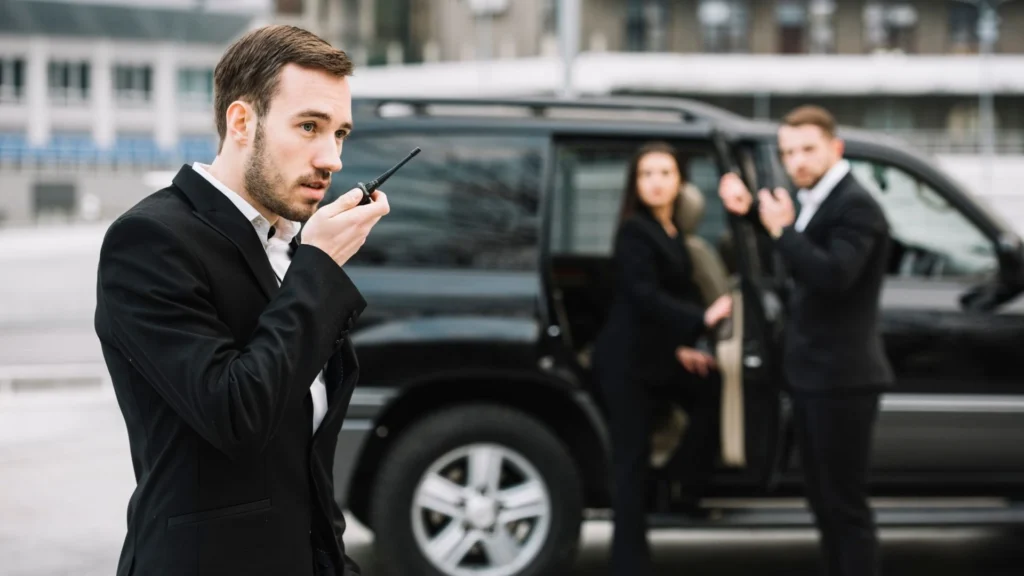 ARMSTEL Super Assistant team coordinating VIP protection near vehicle during executive operation